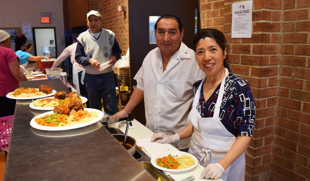 Staff serving food in the dining area
