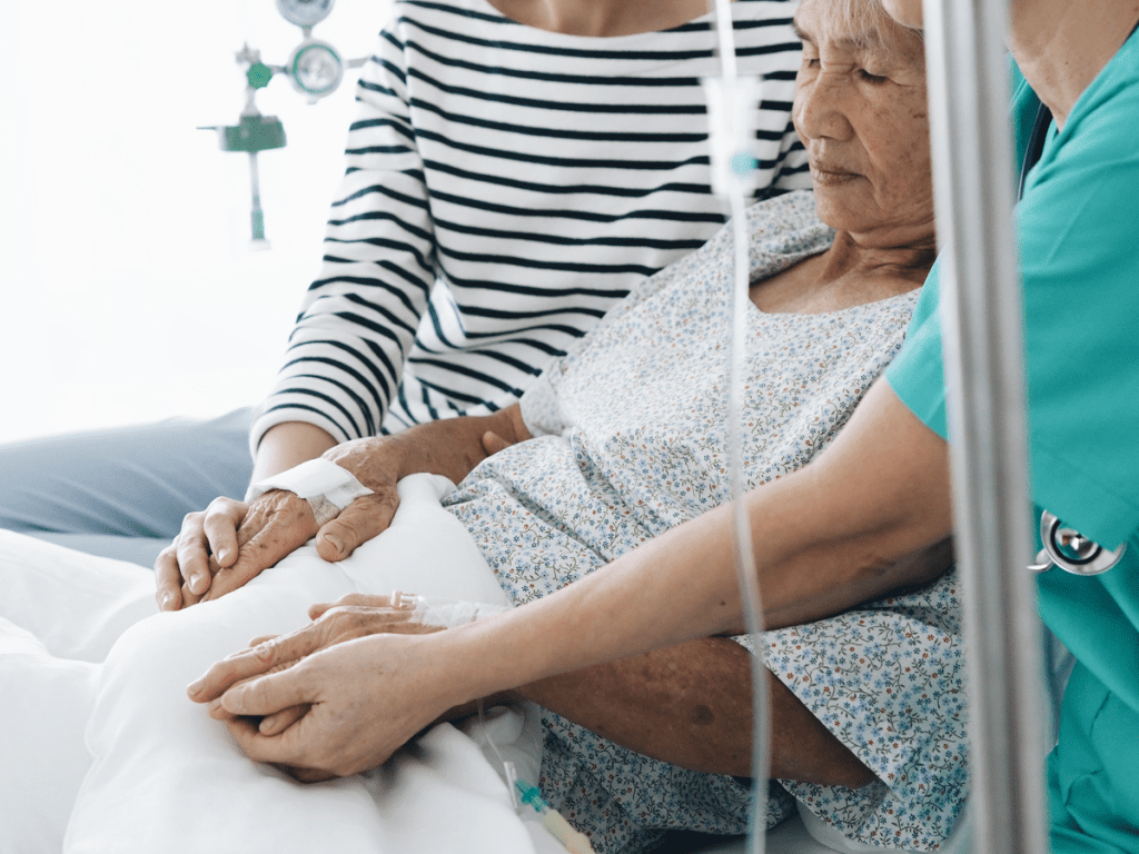Caregiver holding hands with elderly resident