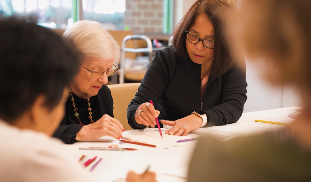 Residents and staff engaging in an arts activity.