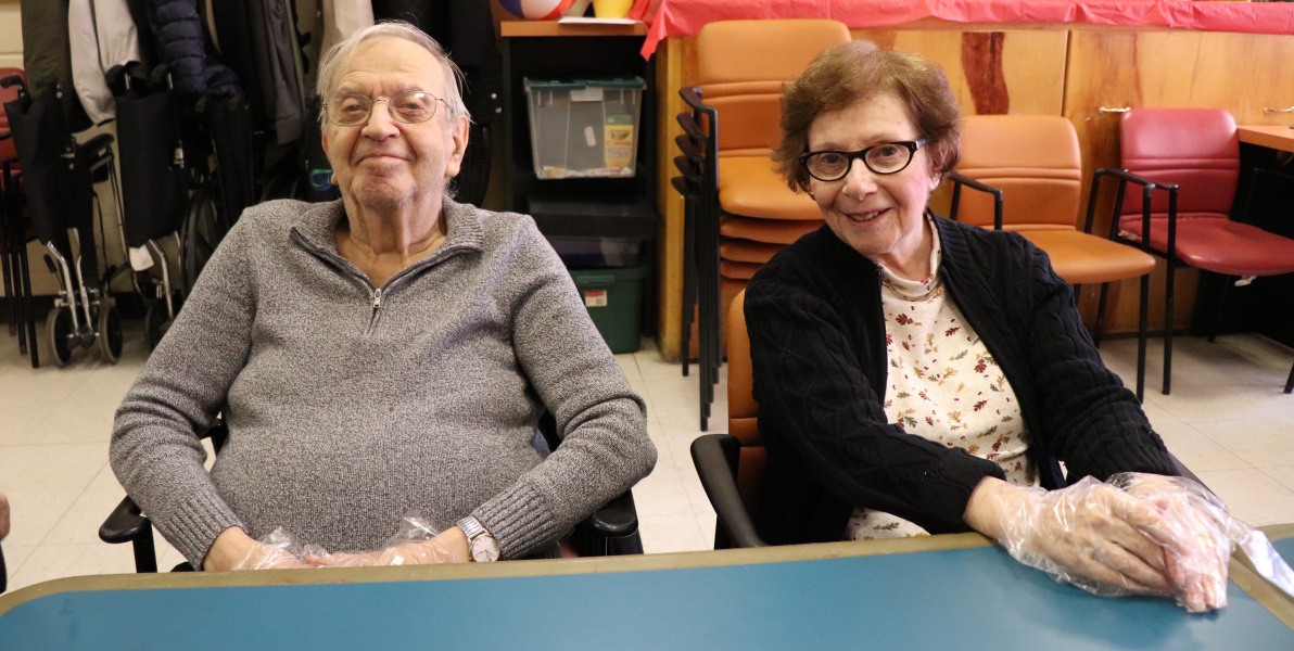 Two residents seated at a common area table.
