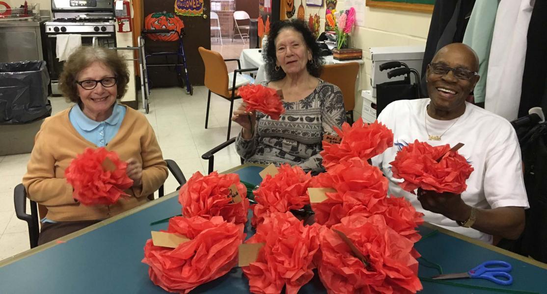 Residents making crafts together in a common area.