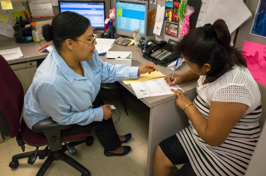 Two women discussing at a desk in an office