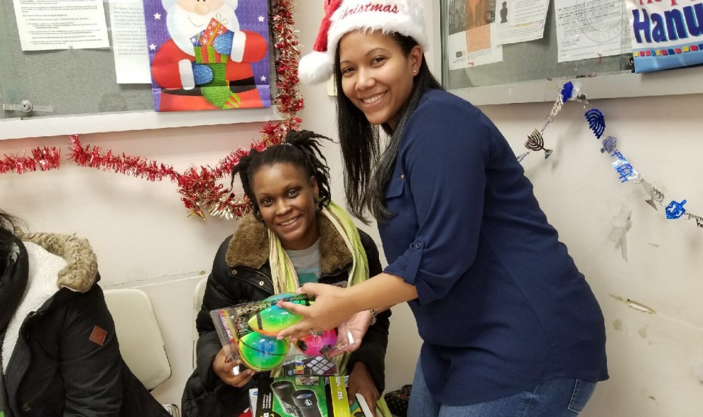 Residents participating in a holiday event with gifts.