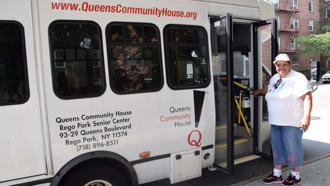 Senior resident near transport van at Queens Community House