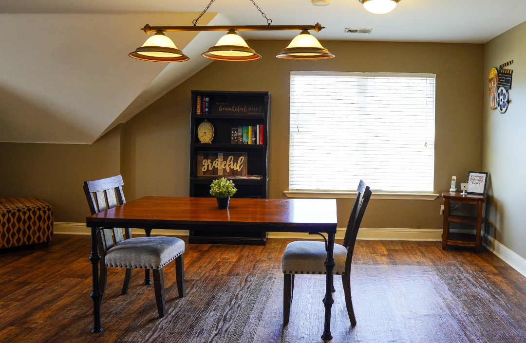 Cozy dining area with a table and chairs.
