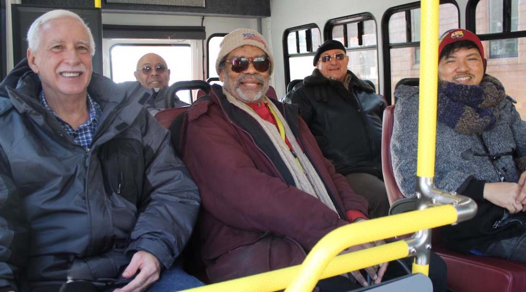 Residents enjoying a ride on a facility bus.