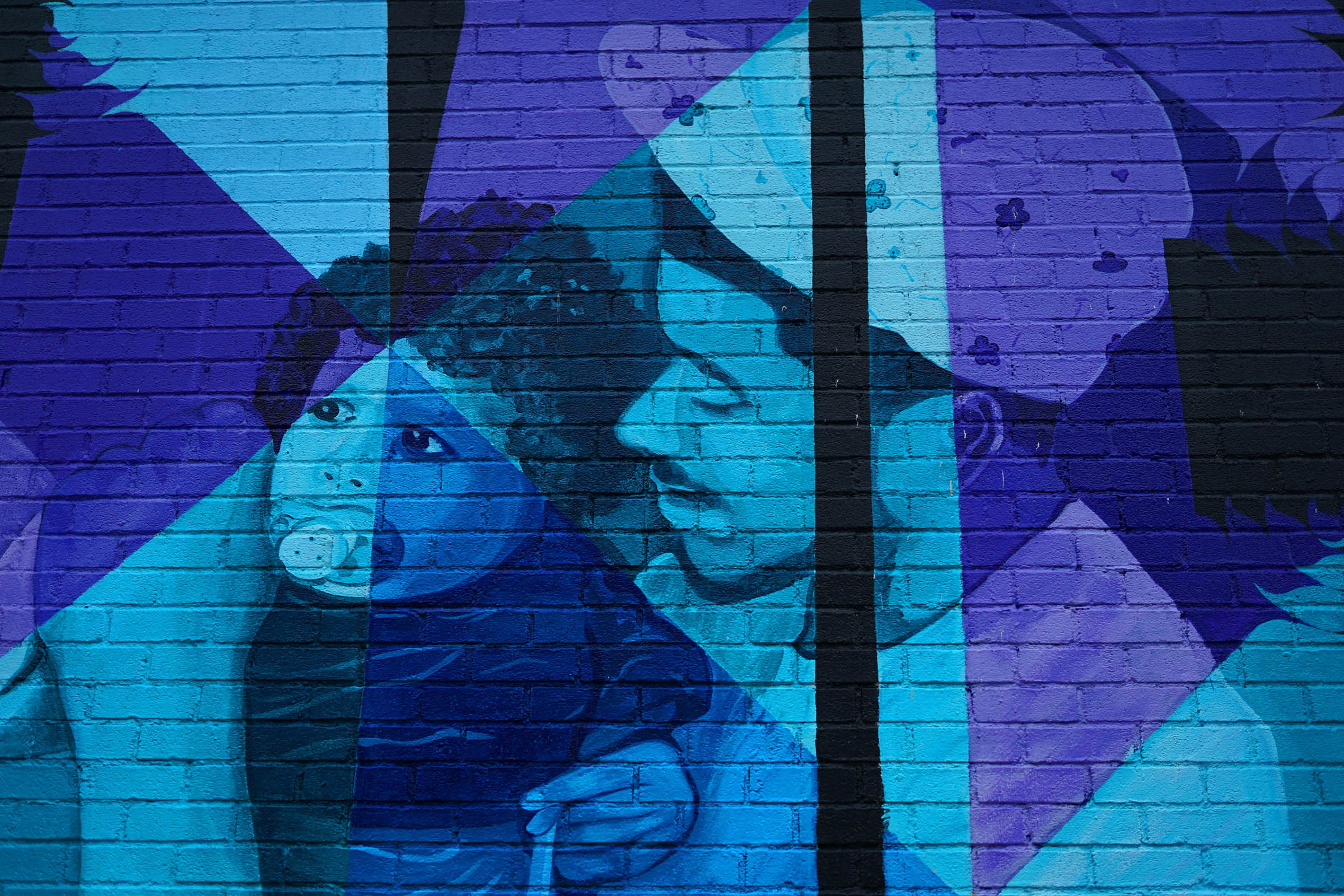 Colorful mural depicting a parent and child.
