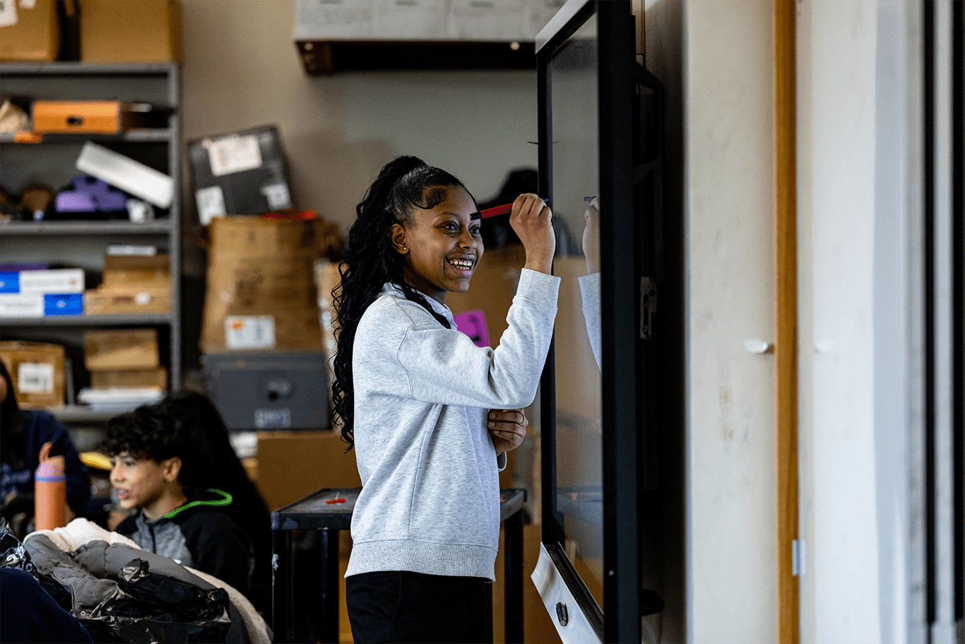 Young woman interacting with a digital board