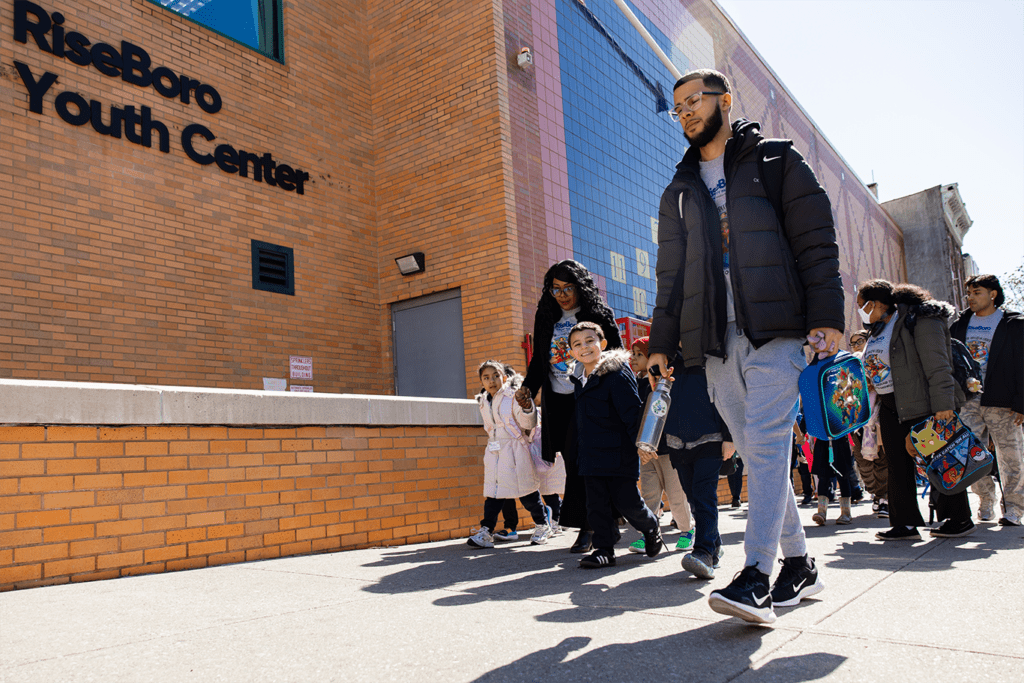 Group of people walking outside a community center