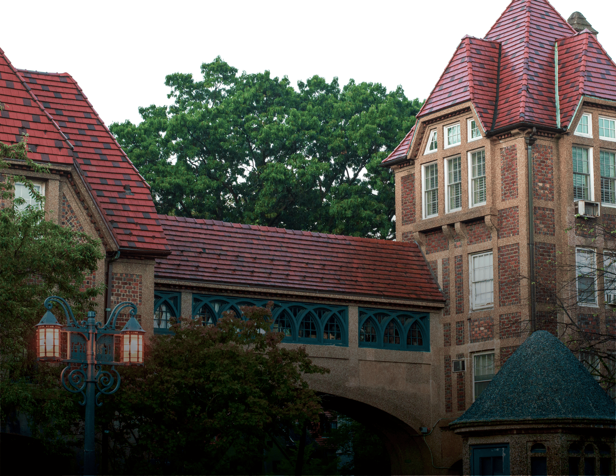 Exterior view of a building with a bridge and trees
