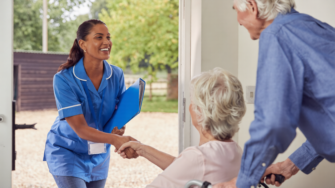 Healthcare worker greeting elderly residents at the entrance