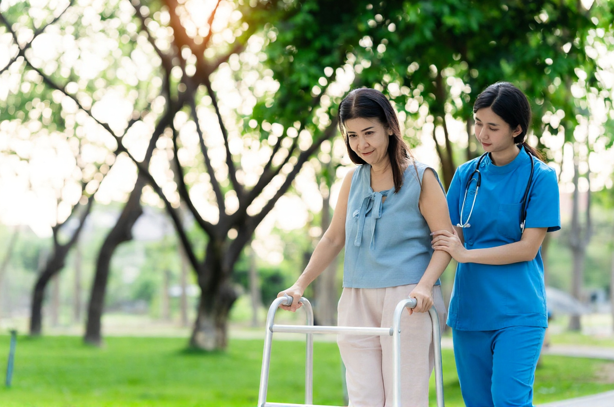 Healthcare professional assisting a resident outdoors