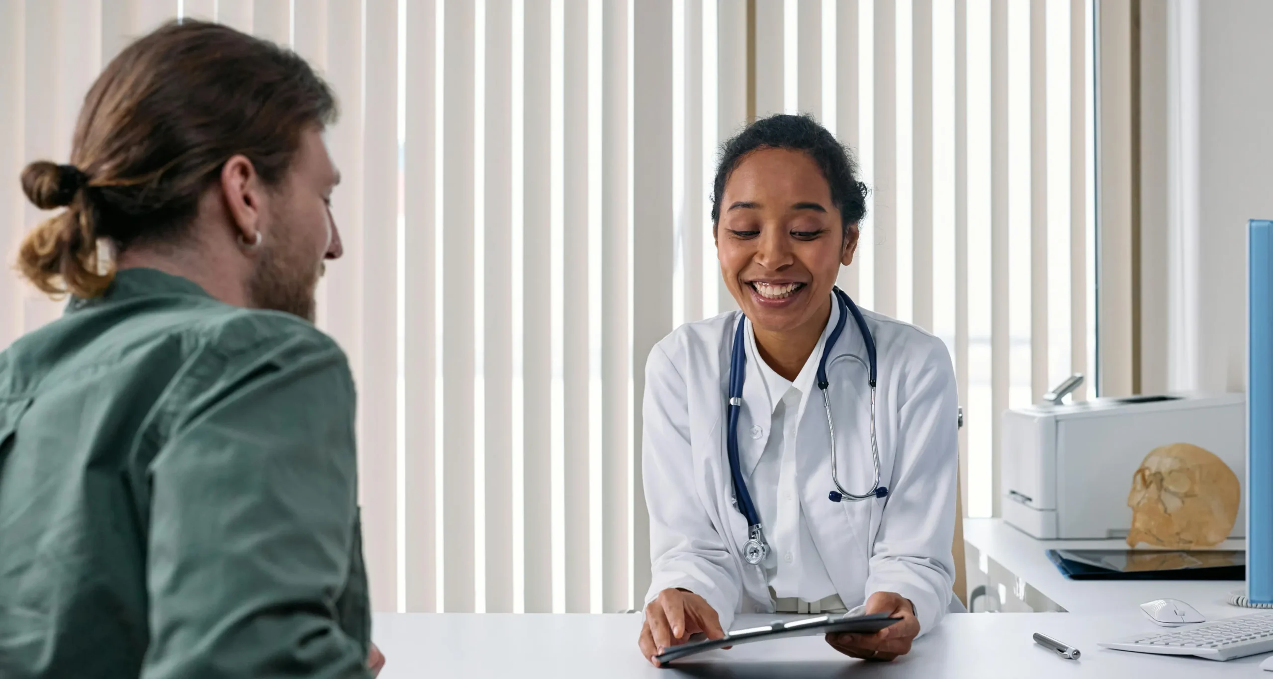 A doctor discussing a tablet with a patient.