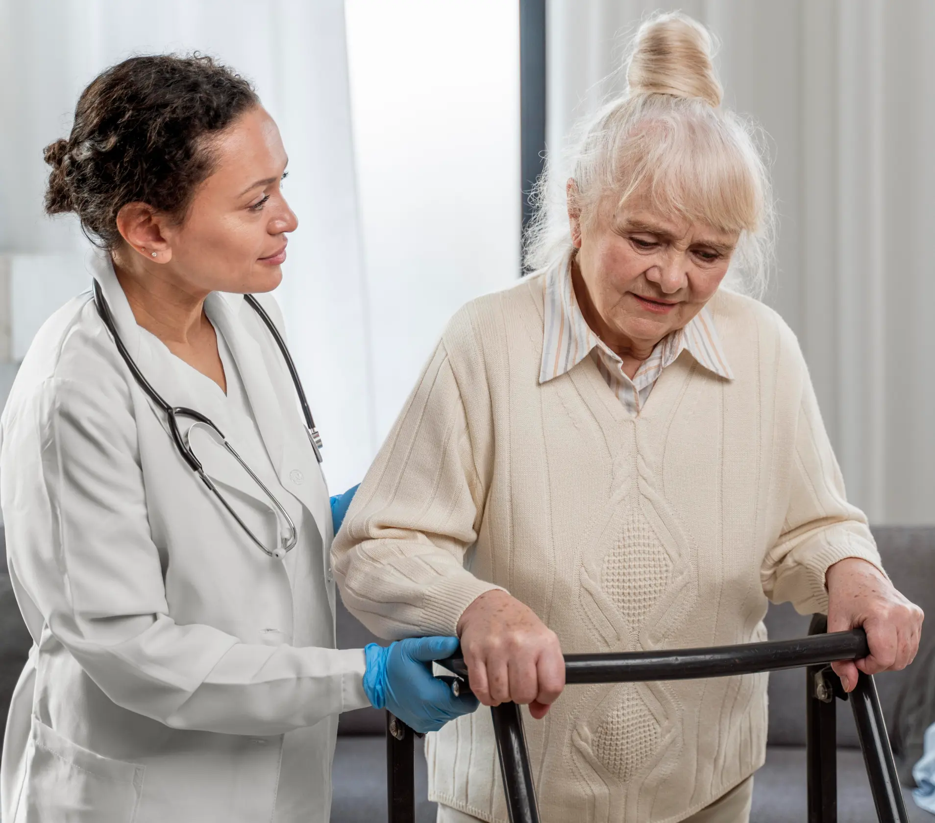Healthcare professional assisting an elderly woman with a walker.