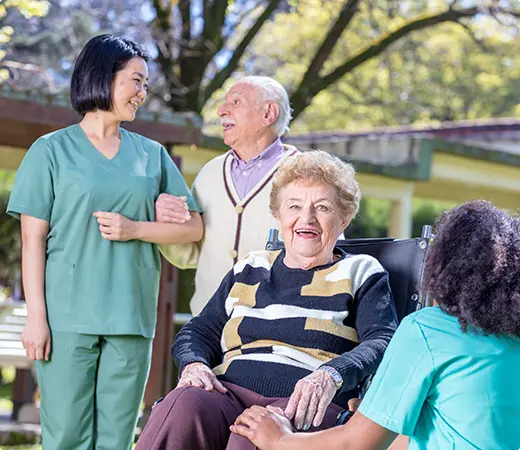 Residents and staff interacting in an outdoor space