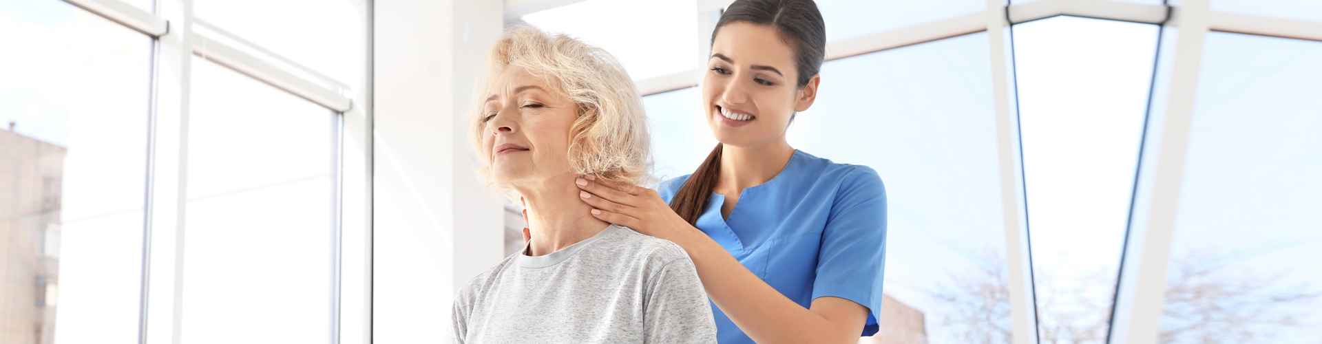 Resident enjoys a shoulder massage from staff