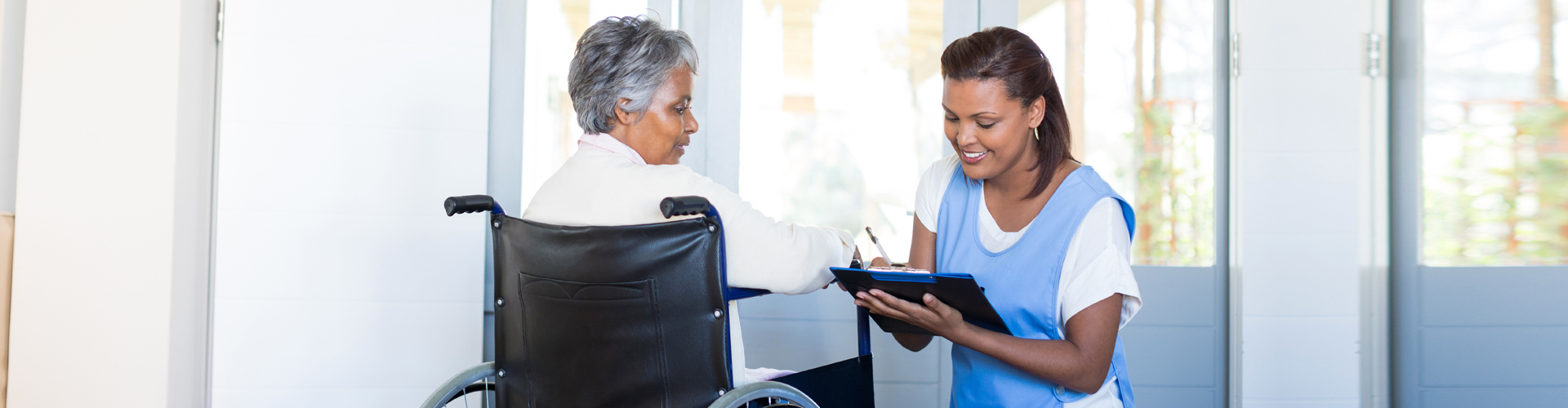 Caregiver assisting a resident in a facility.