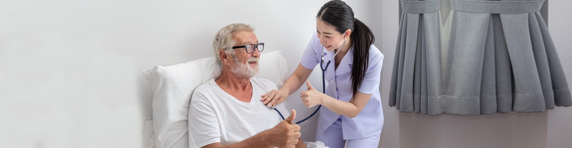 Nurse caring for an elderly man in a room