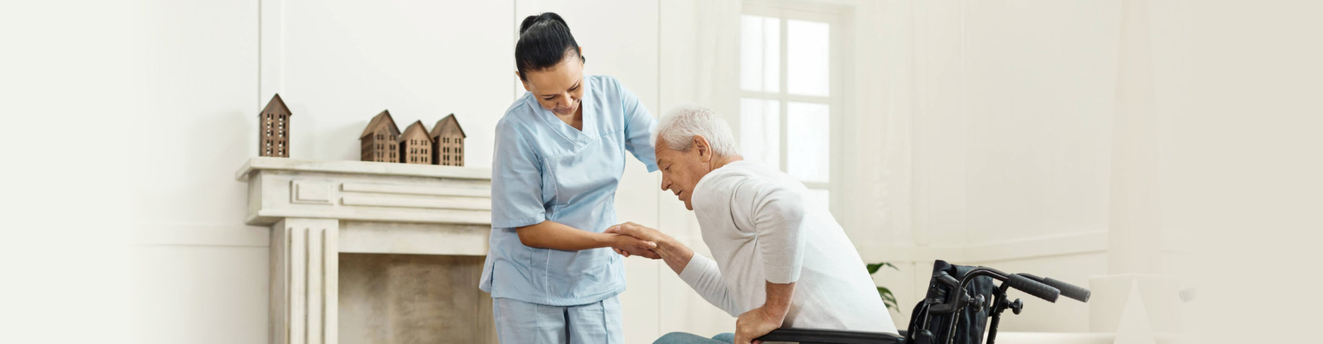 Care staff assisting a resident indoors