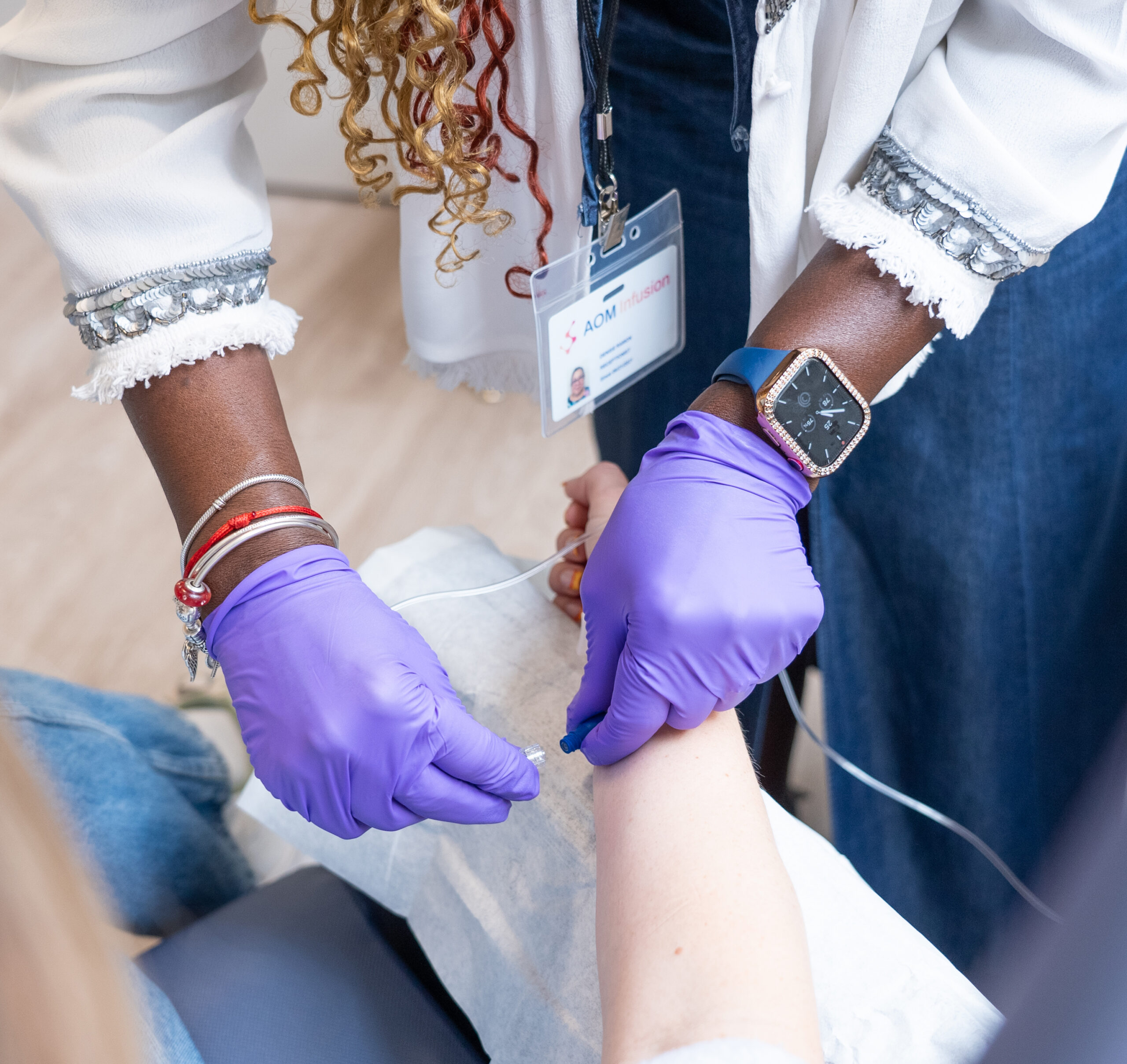 Nurse administering infusion treatment to a resident