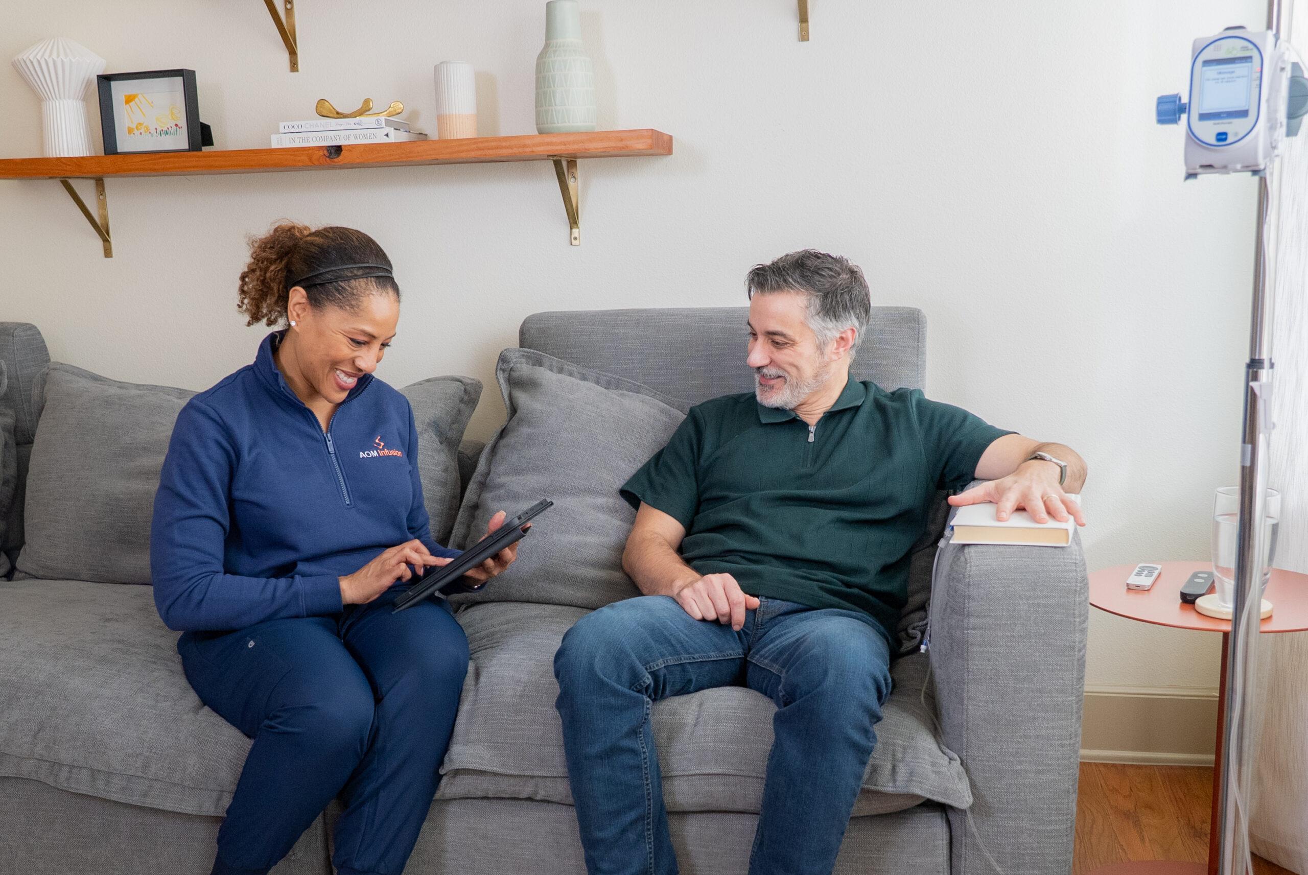 Staff member assisting a resident on the couch.