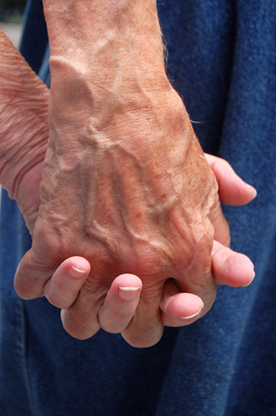 Two hands holding, symbolizing connection and care.
