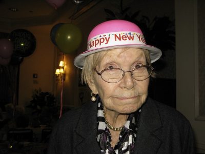 Elderly woman wearing a festive New Year's hat