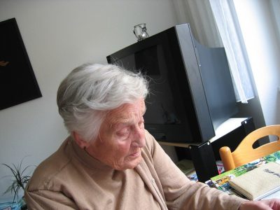 Senior woman engaged in an activity indoors.