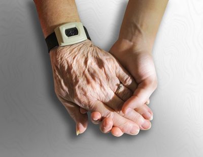 Close-up of two hands holding each other.