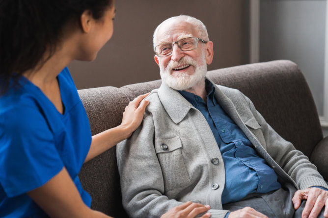 Caregiver chatting with a senior resident