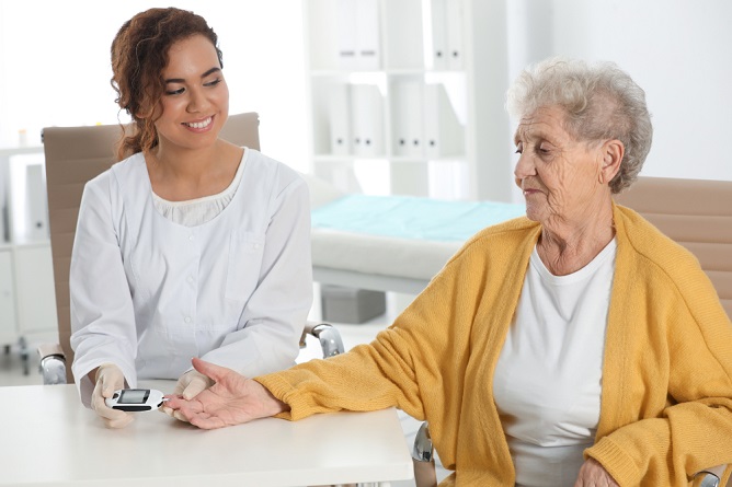Healthcare interaction between staff and resident.
