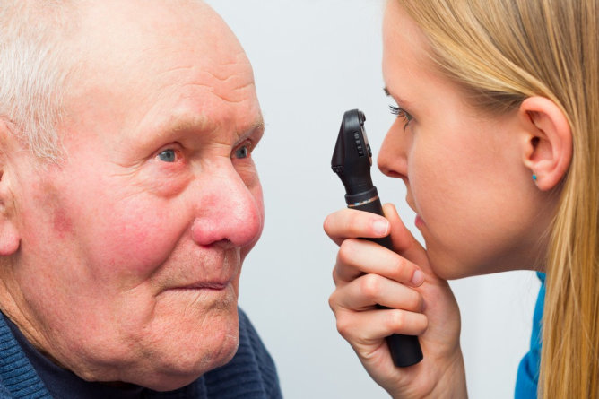 Elderly man receiving an eye examination.