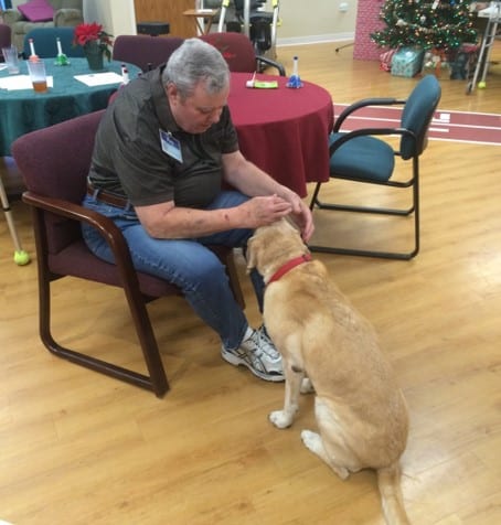 Resident interacting with a dog at the center.
