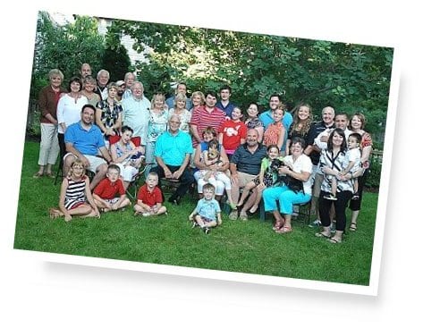 Group photo of residents and community members outdoors.