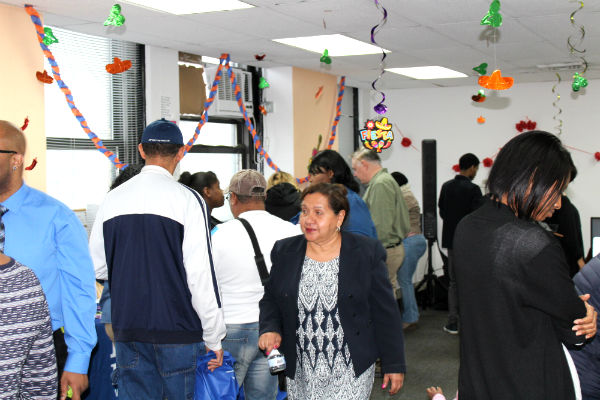 Residents and staff celebrating in a decorated room.