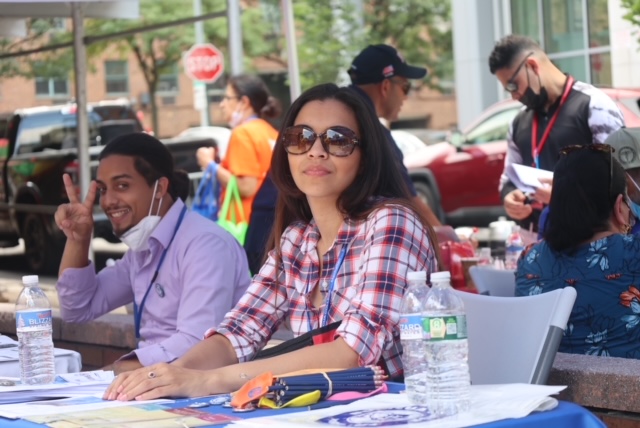 Staff members interacting outdoors at an event.