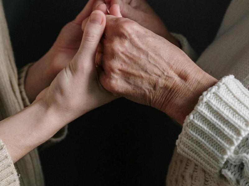 Two hands holding, showcasing connection and care.