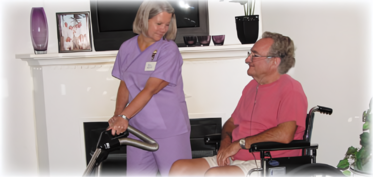 Staff assisting a resident in a living area.