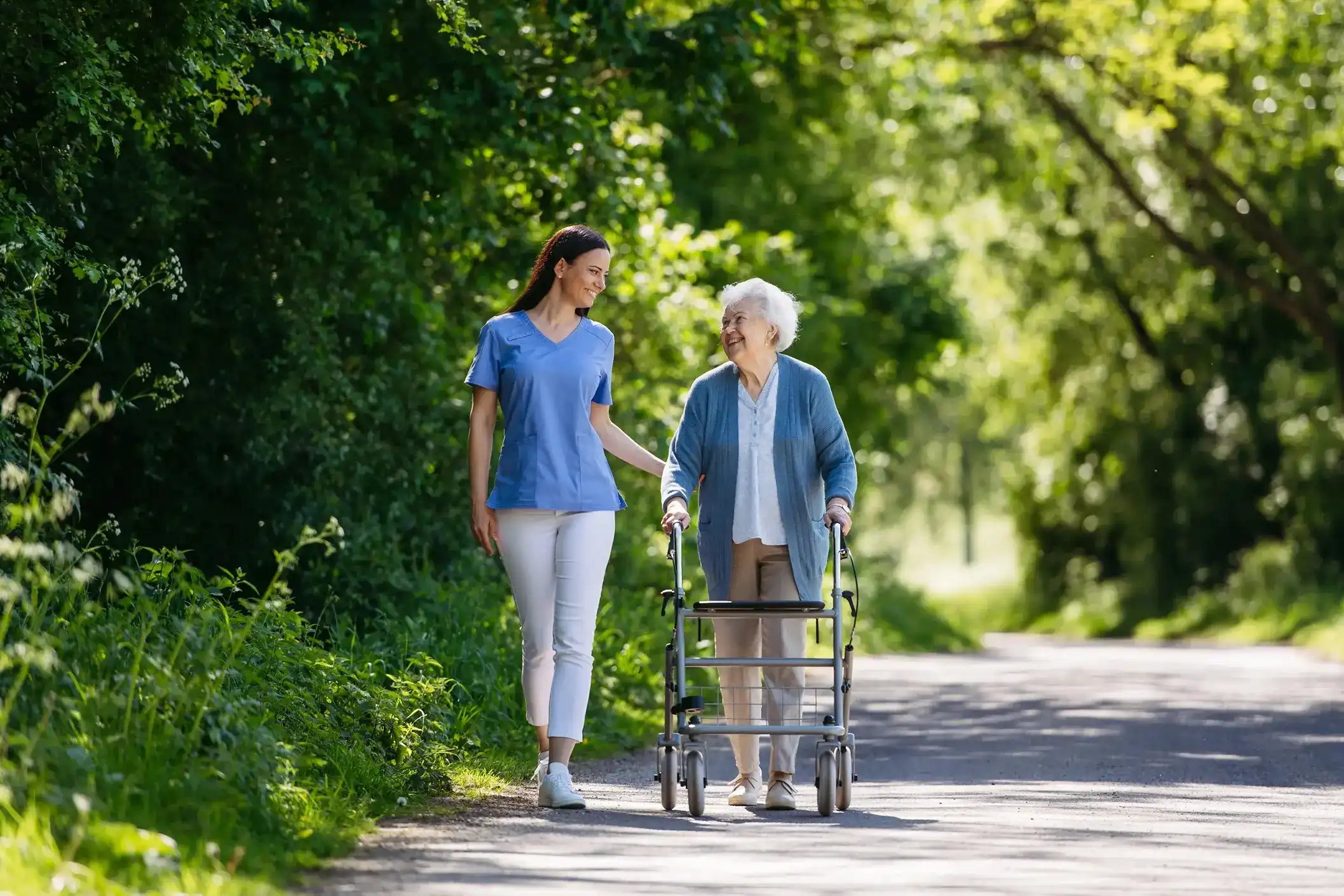 Caregiver assisting a senior in a park