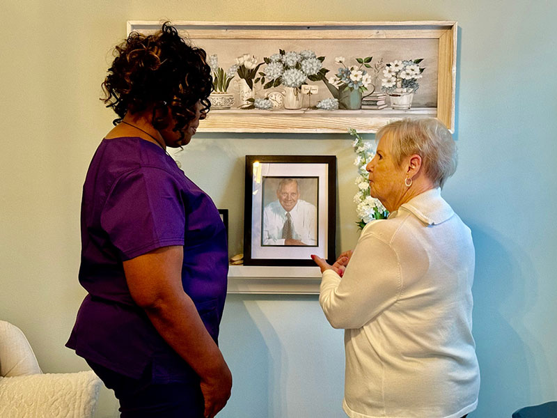 Staff member and resident engaging with a photo.