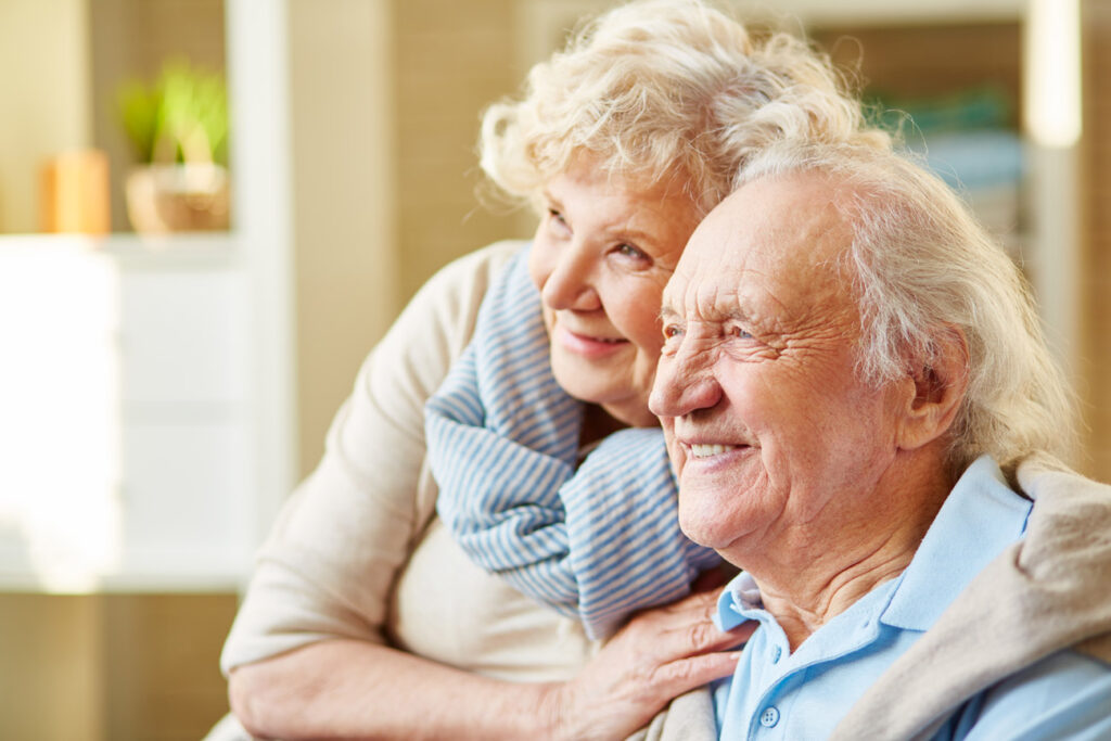 Happy elderly couple enjoying time together indoors.