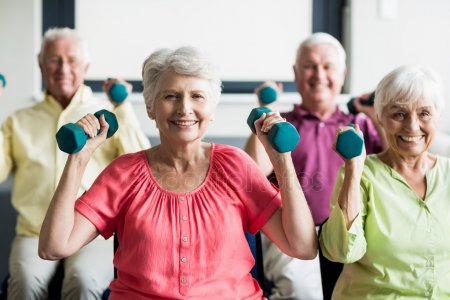 Seniors exercising with dumbbells in a common area