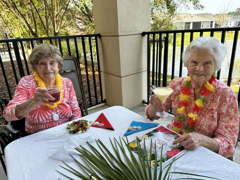 Two residents enjoying drinks outdoors