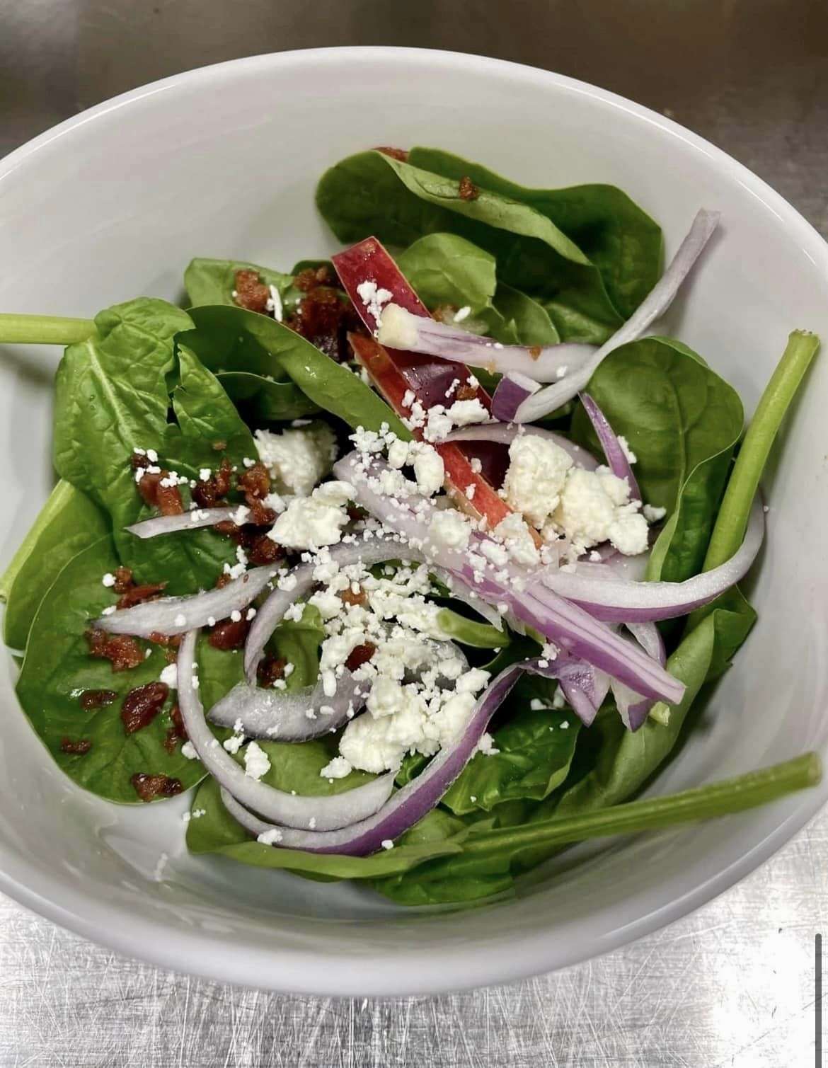 Fresh salad with spinach, onions, and cheese