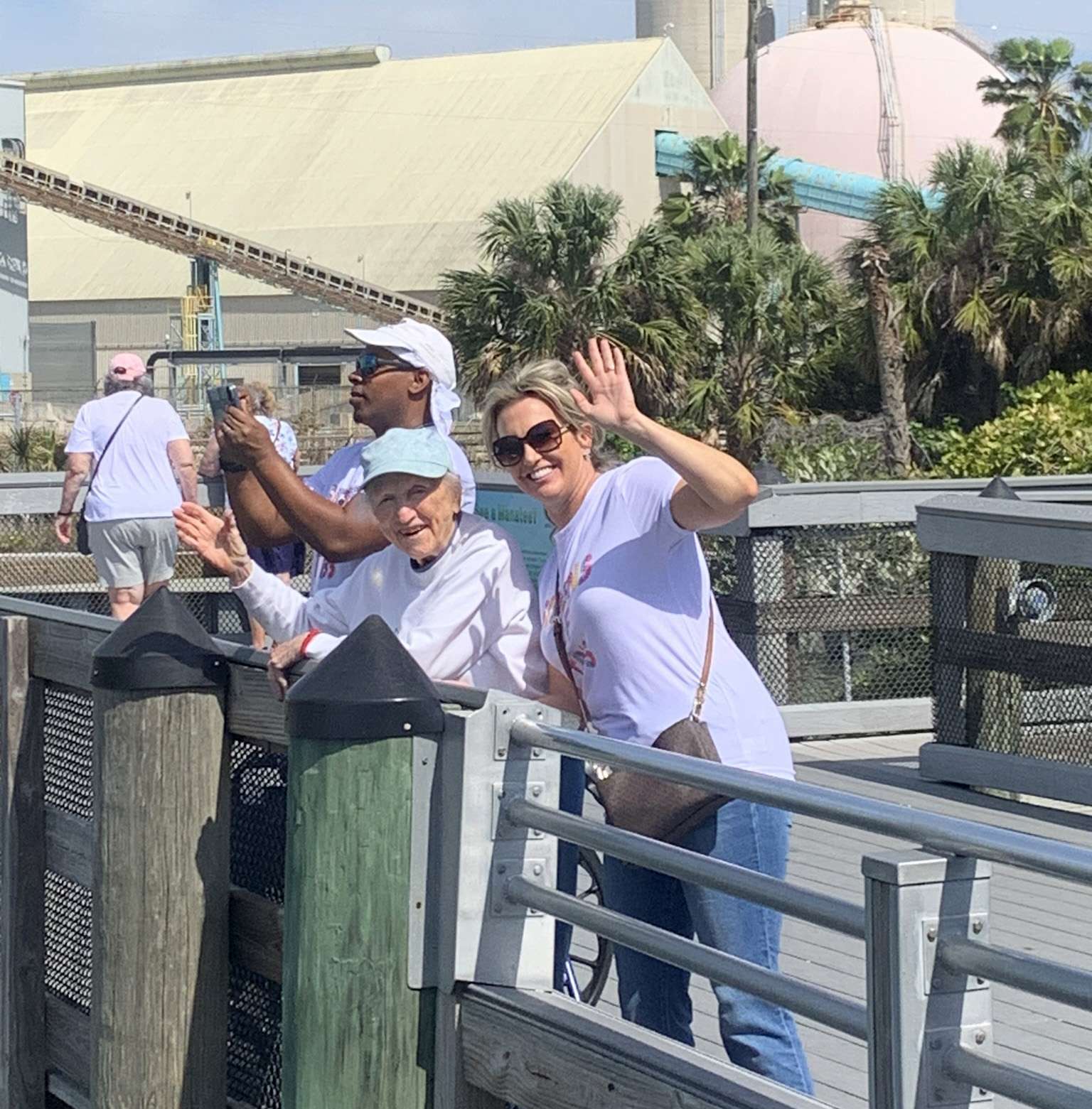 Residents enjoying an outdoor activity and waving.