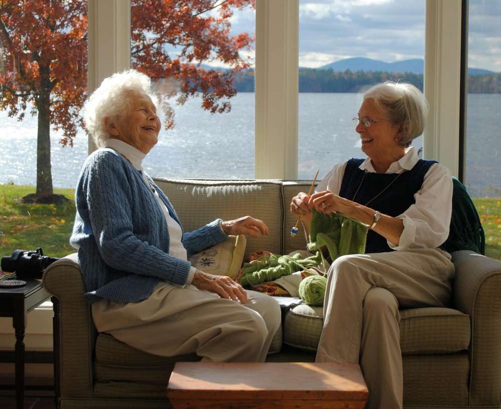 Two senior women enjoying time together indoors