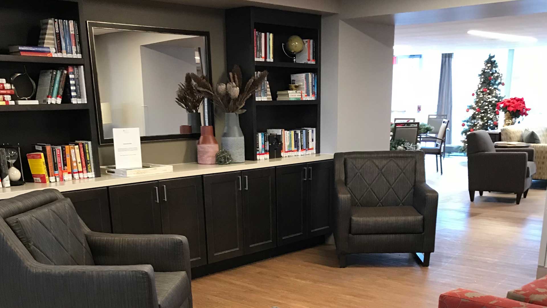 Cozy common area with bookshelves and holiday decor