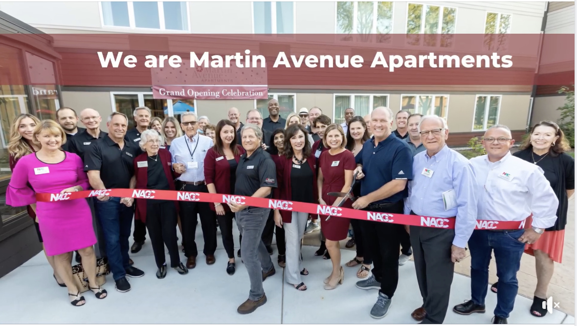 Celebration with staff and community members at ribbon-cutting event.