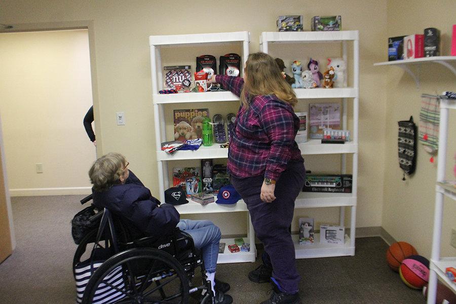 Resident and staff member interact in common area.