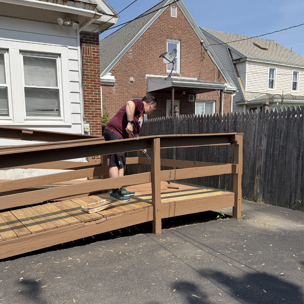 Person working on a wooden ramp outside